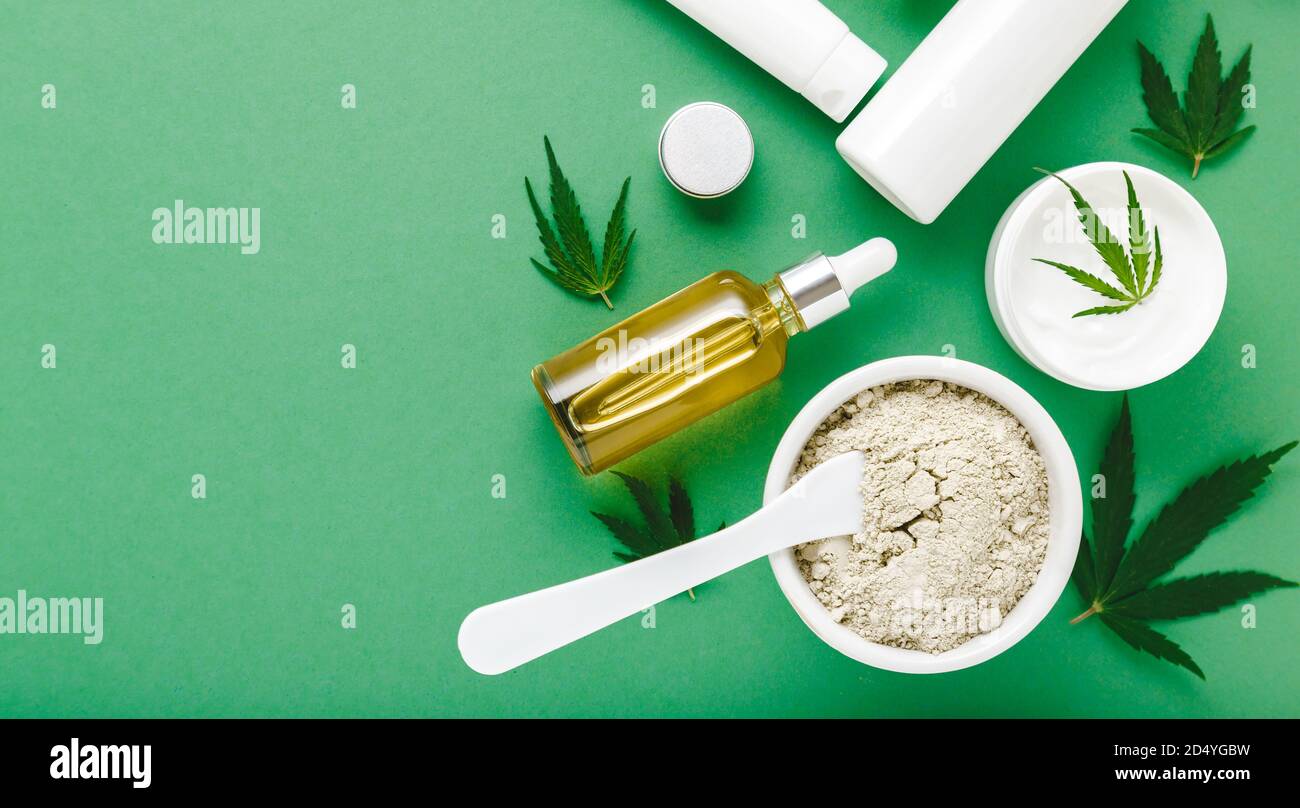 Moisturizing cream, Serum, lotion, CBD oil, essential oil cannabis leaves. Set of hemp skin care cosmetics in white mockup packaging. Flat lay on Stock Photo