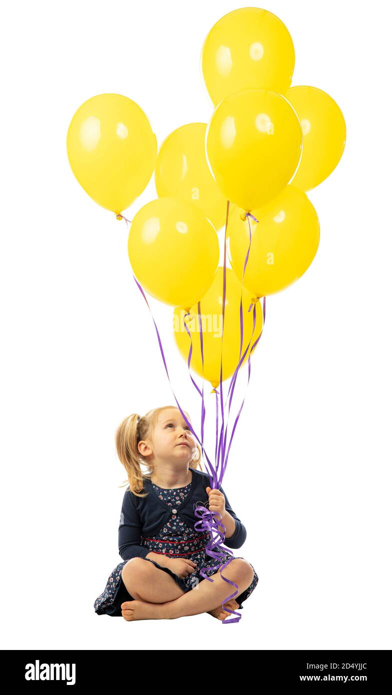 caucasian blond little girl with yellow balloons isolated on white. Stock Photo