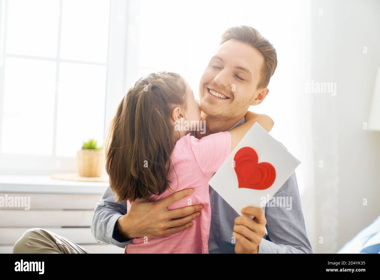 Happy father's day! Child daughter congratulating dad and giving him ...