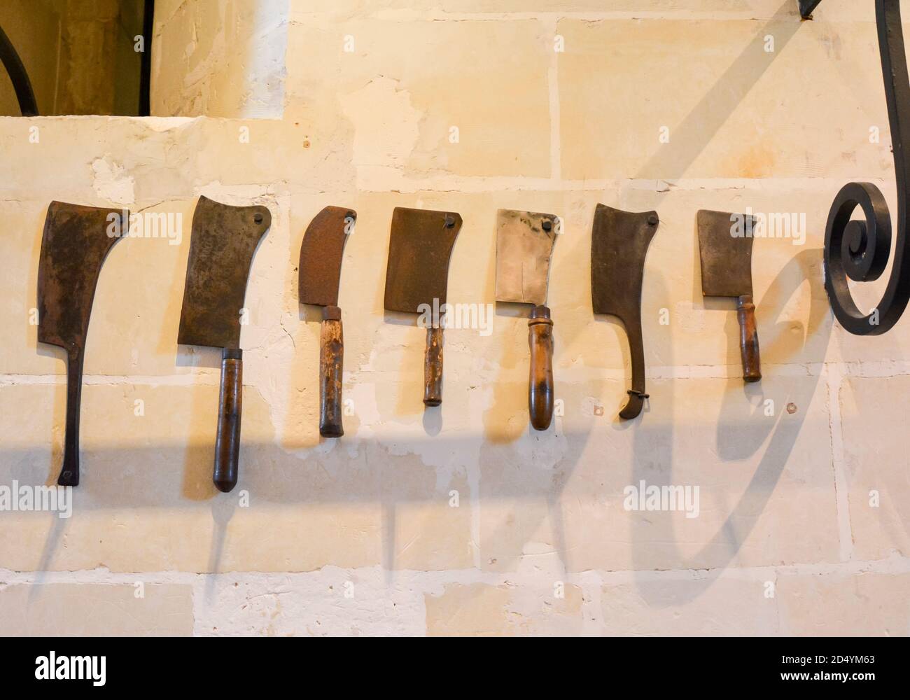 Vintage Butcher meat cleavers on a stone wall in Chenonceau castle