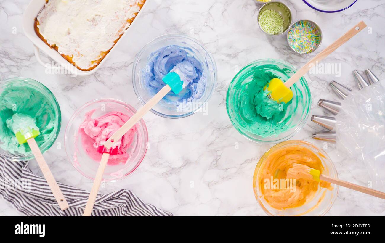 Mixing food coloring into Italian buttercream frosting Stock Photo Alamy