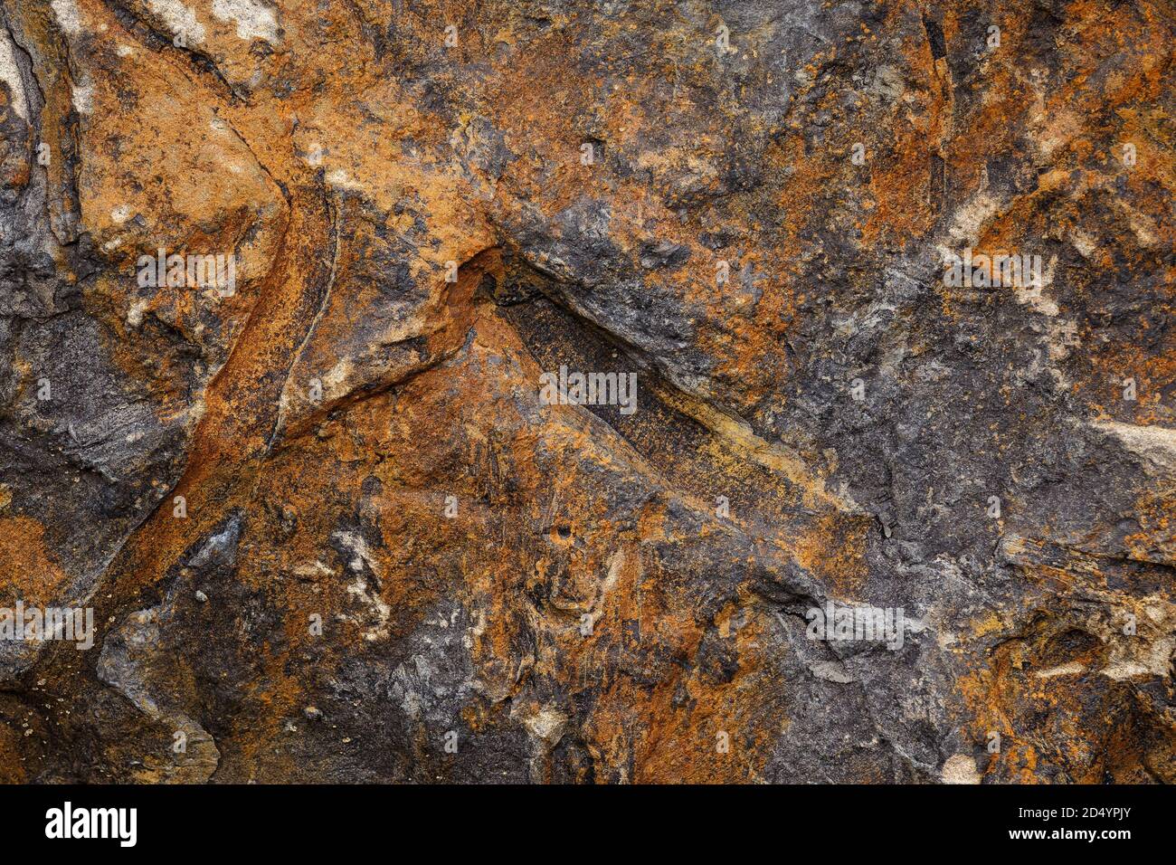 The surface of the natural stone reddish color with cracks and prints Stock Photo