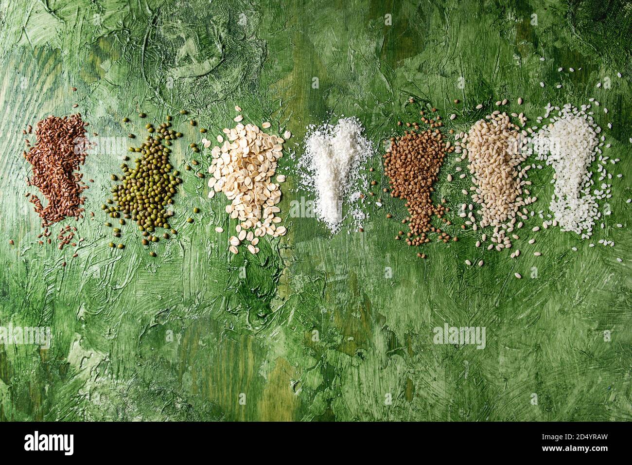 Variety of raw uncooked grains superfood cereal linen seeds, sesame, mung bean, wheat, buckwheat