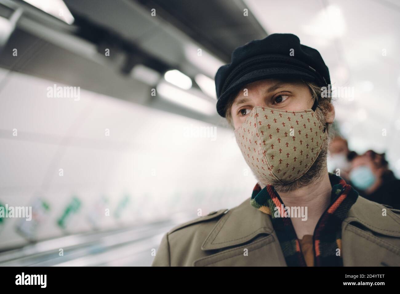 Man wearing a face mask in the underground Stock Photo
