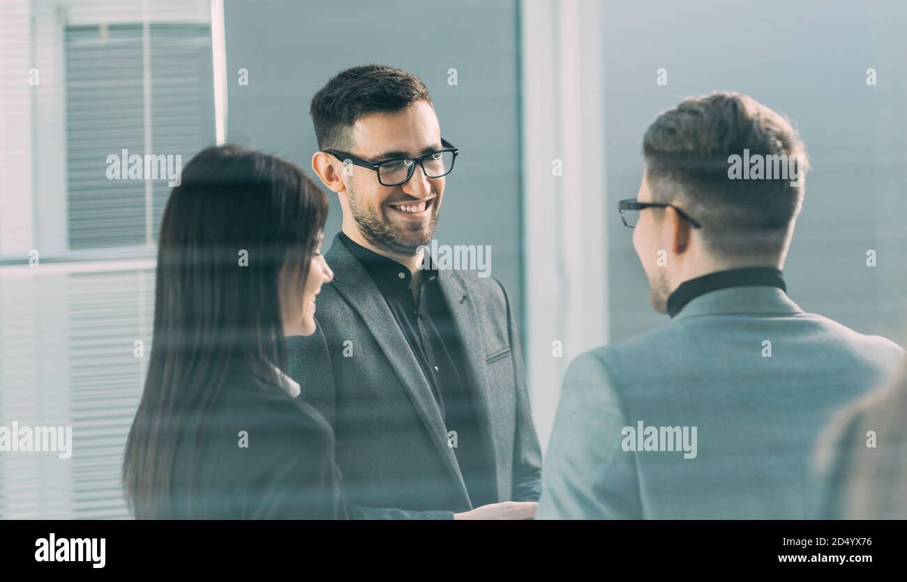 young colleagues are talking standing in the office Stock Photo - Alamy