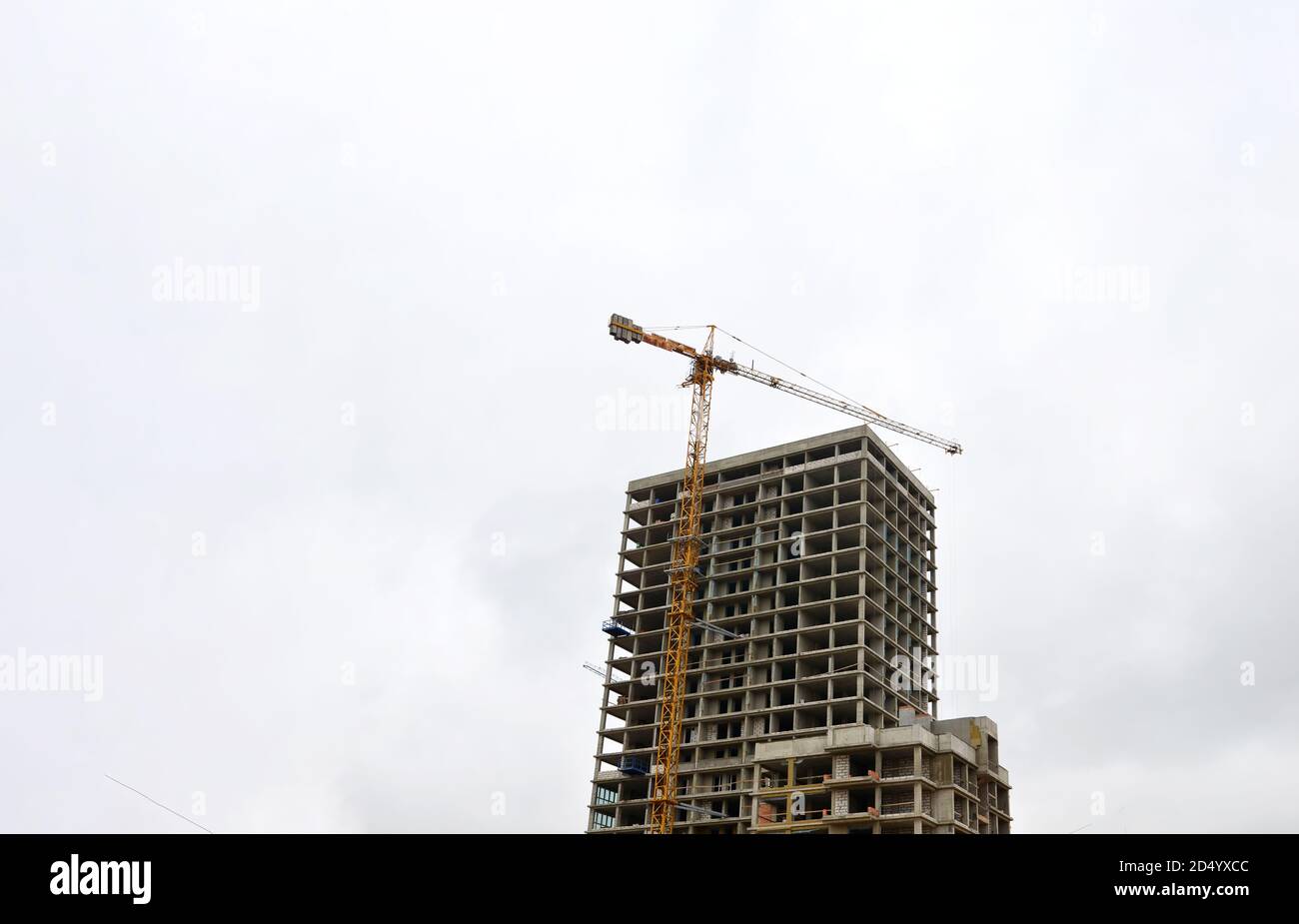 Tower cranes constructing a new building at construction site. Stock Photo