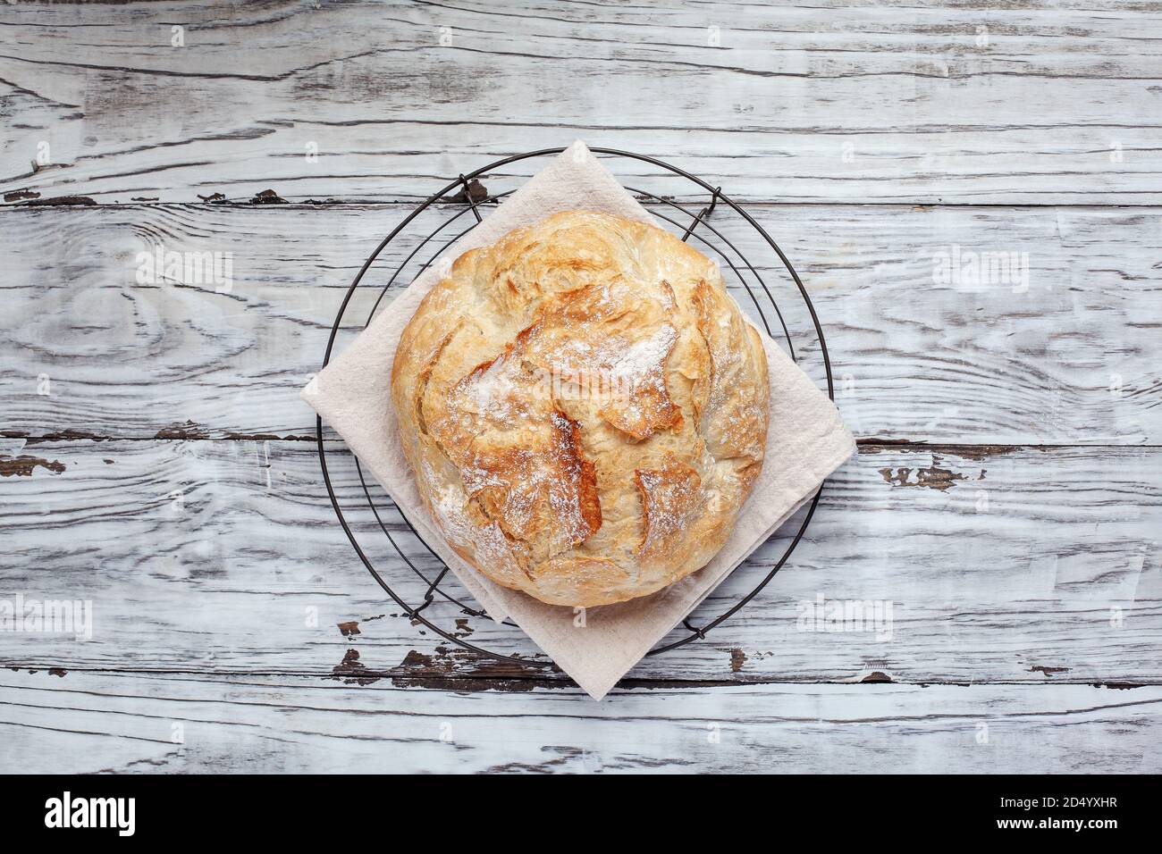 Top view of fresh homemade artisan bread cooling on a bakers rack. Flatlay. Stock Photo
