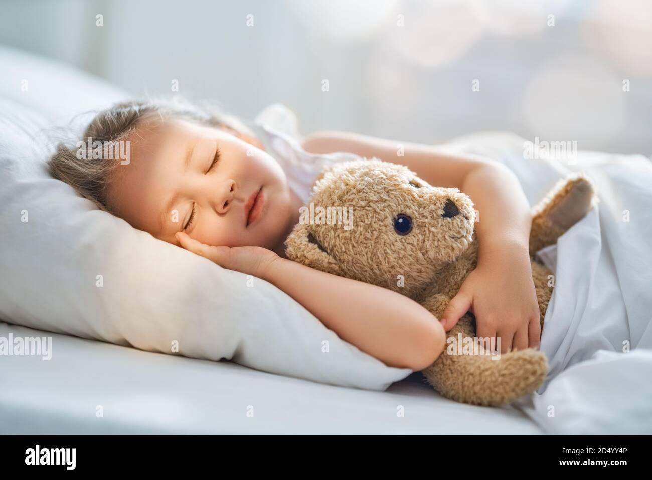 Baby hugging teddy bear hotsell