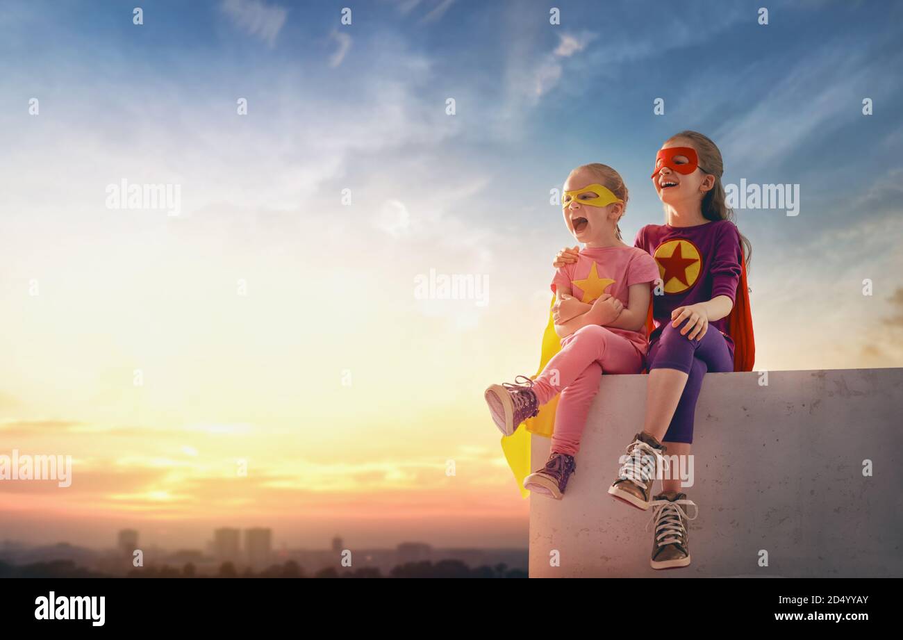Little Children Playing Superhero Kids On The Background Of Sunset Sky Girls Power Concept Stock Photo Alamy