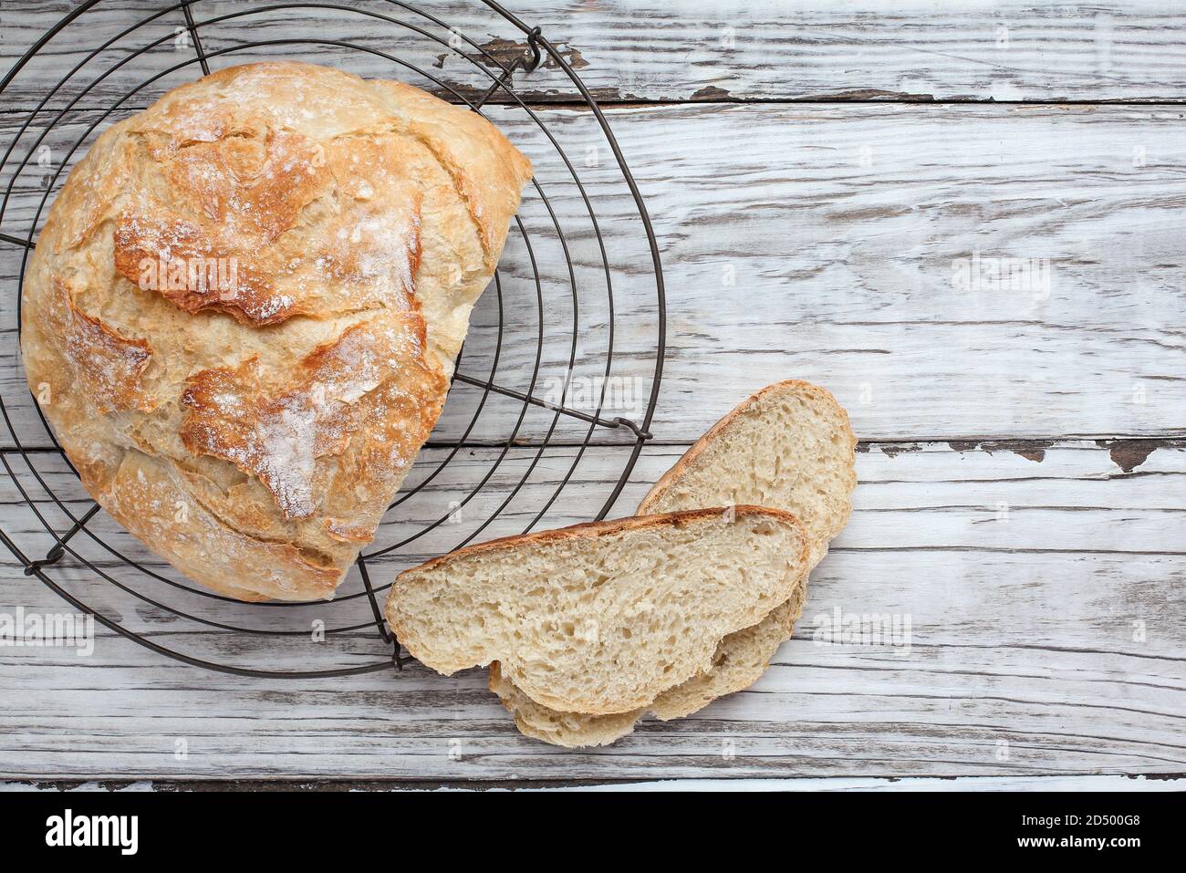 Top view of fresh homemade artisan bread cooling on a bakers rack. Flatlay. Stock Photo