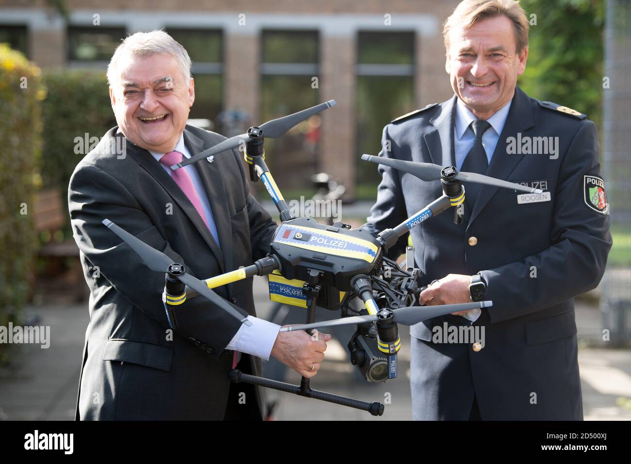 Neuss, Germany. 12th Oct, 2020. Herbert Reul (CDU, l), Interior Minister of North Rhine-Westphalia, and Thomas Roosen, Director of the State Office for Central Police Services, hold a drone for the police in their hands. After a pilot phase, drones will go into regular service with the North Rhine-Westphalian police. Credit: Federico Gambarini/dpa/Alamy Live News Stock Photo
