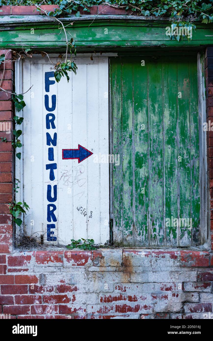 "Furniture" sign painted onto a boardedup window Stock Photo Alamy