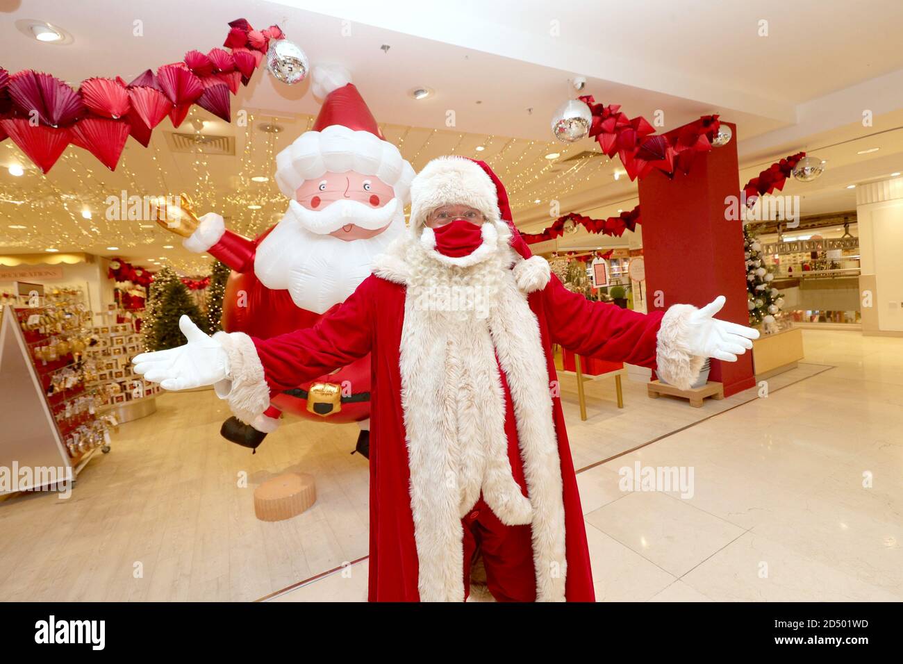 A man dressed as Father Christmas, wearing a protective face covering, at the launch of the Selfridges Christmas shop at the flagship store on Oxford Street, London. This year's theme has been unveiled as Once Upon A Christmas. Stock Photo