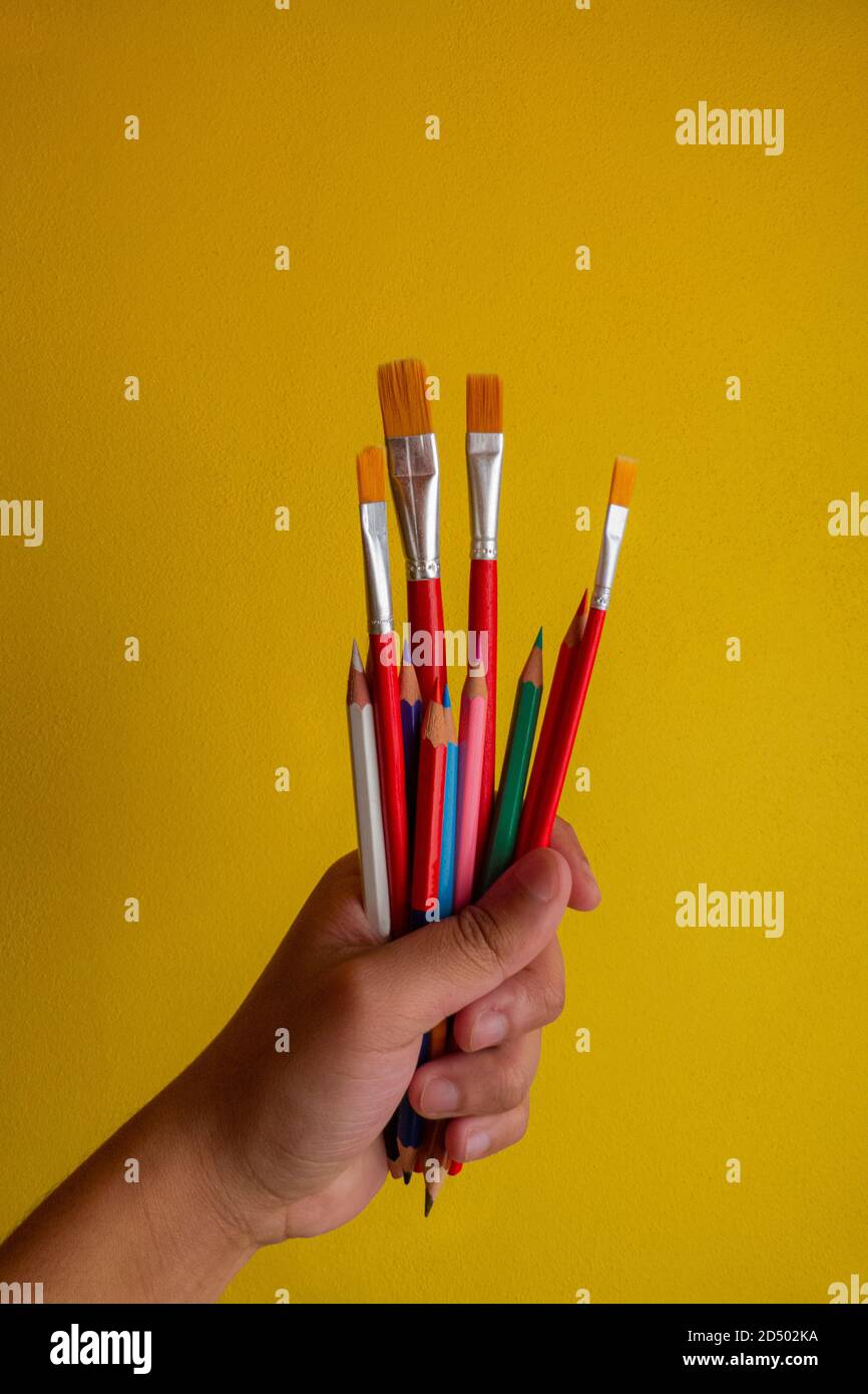 a man's hand holding art or painting materials Stock Photo Alamy