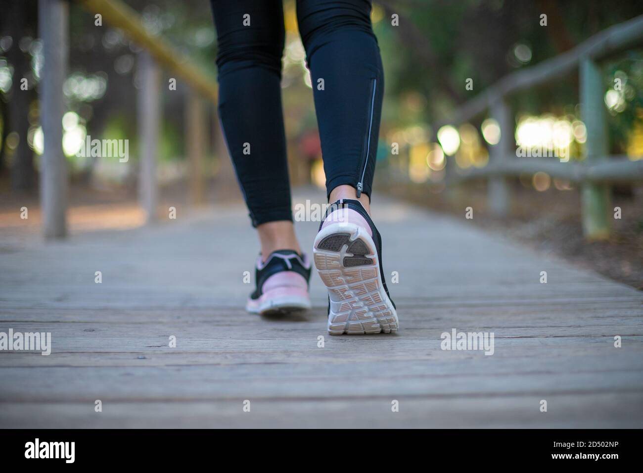 legs of a woman running through the forest Stock Photo - Alamy