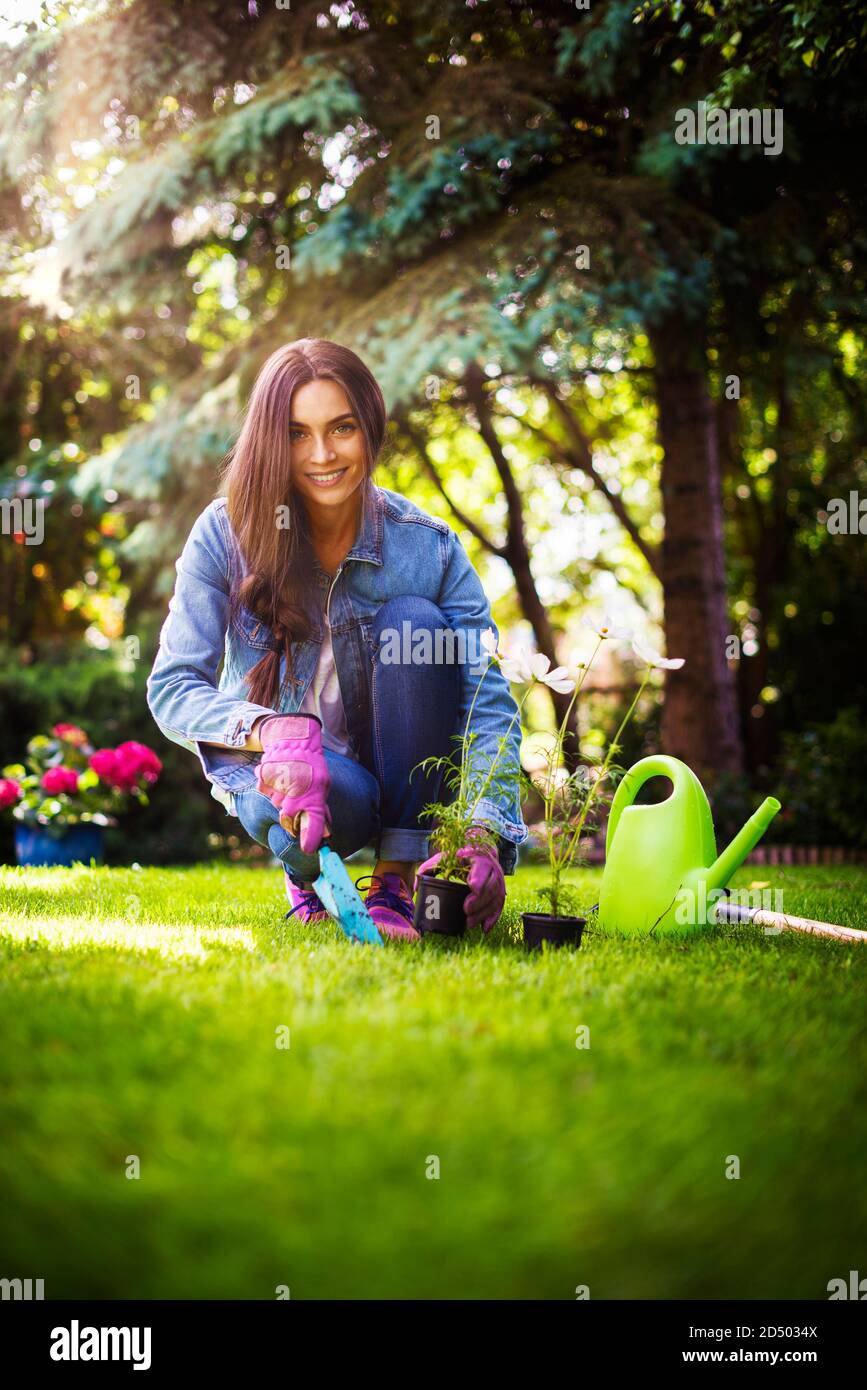 Smiling young women planting hi-res stock photography and images - Alamy