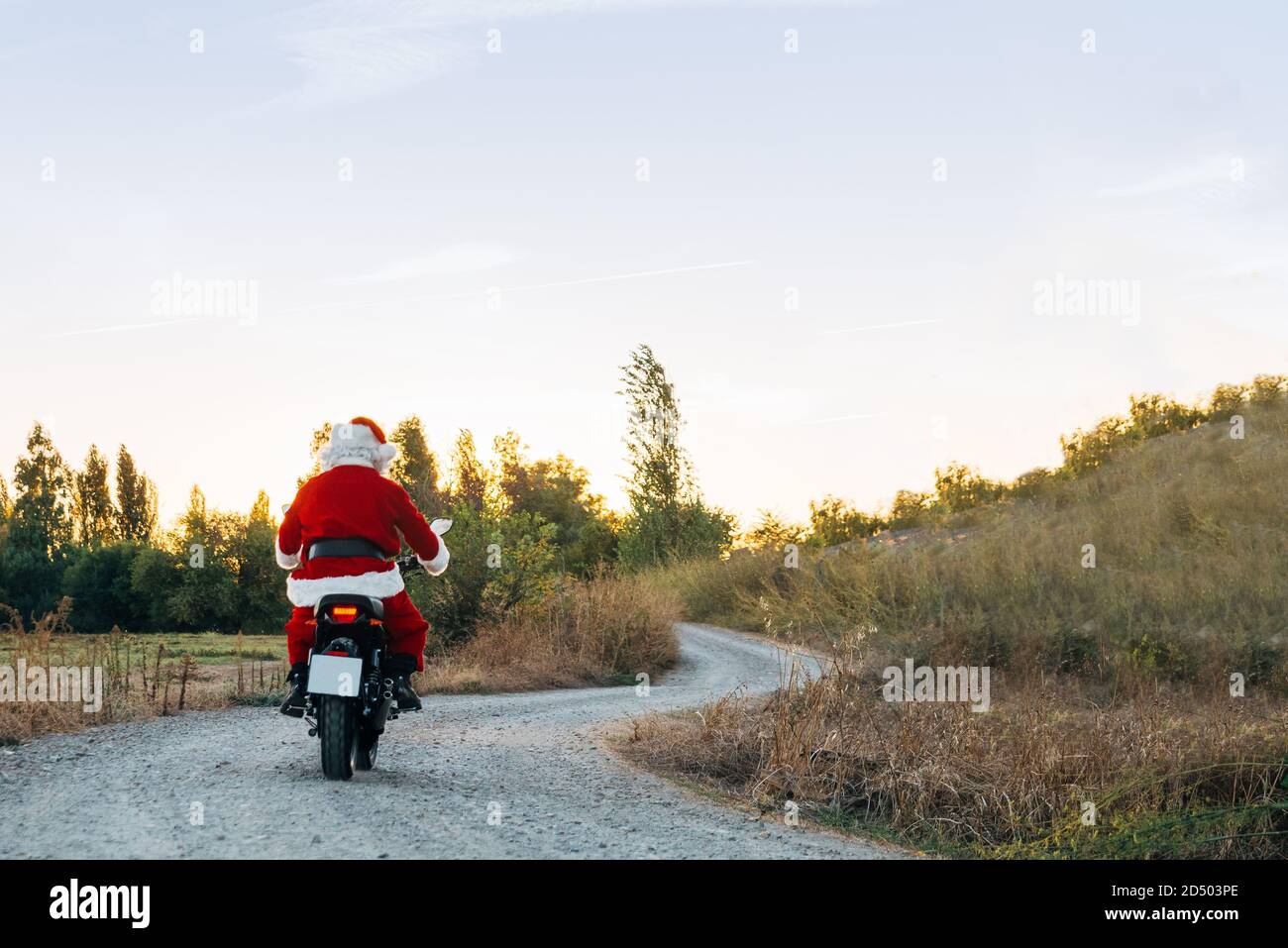 santa claus riding a motorcycle on the road. Stock Photo