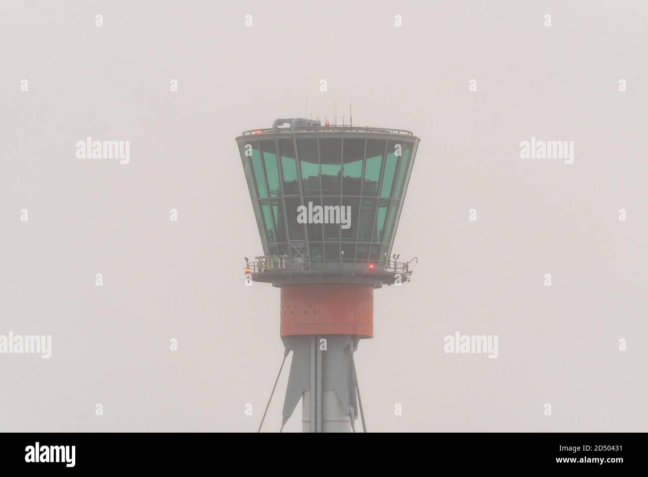 Air Traffic Control Tower at London Heathrow Airport in foggy, rainy bad weather conditions. Heavy clouds, during COVID 19 Coronavirus travel issues Stock Photo