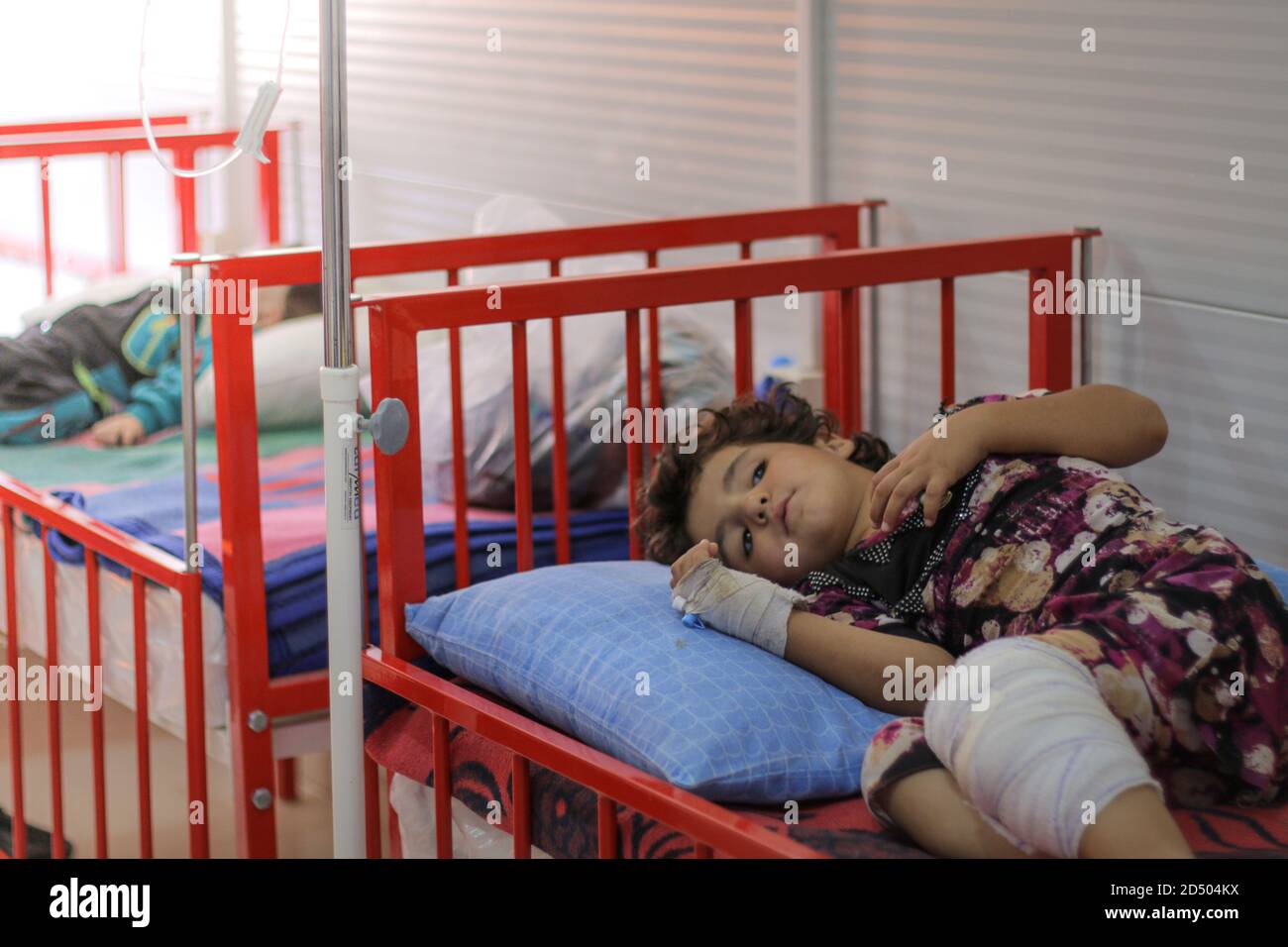 A sick child lies on a hospital bed. Stock Photo