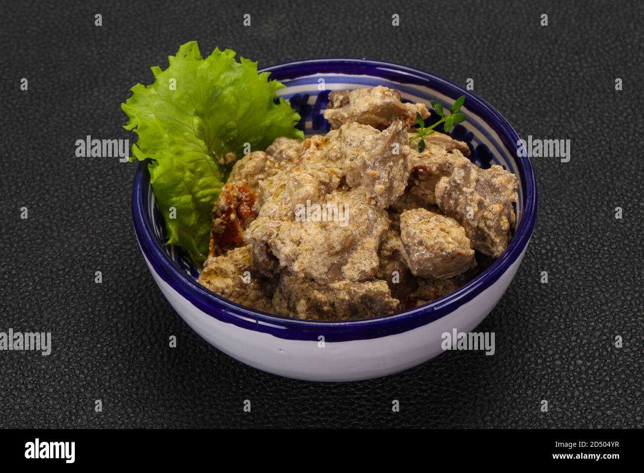 Chicken liver with cream and dry tomatoes served thyme Stock Photo Alamy