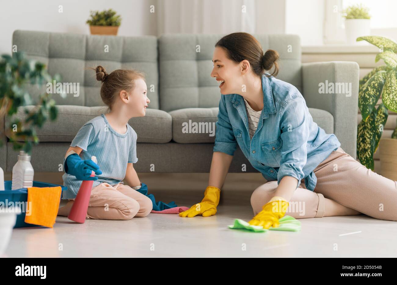 Happy family at home. Mother and daughter doing the cleaning in the ...
