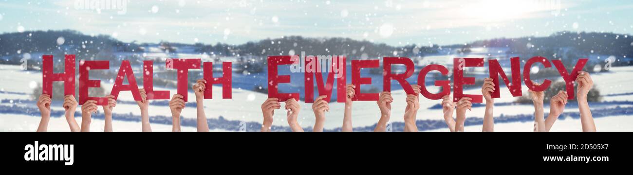 People Hands Holding Word Health Emergency, Snowy Winter Background Stock Photo