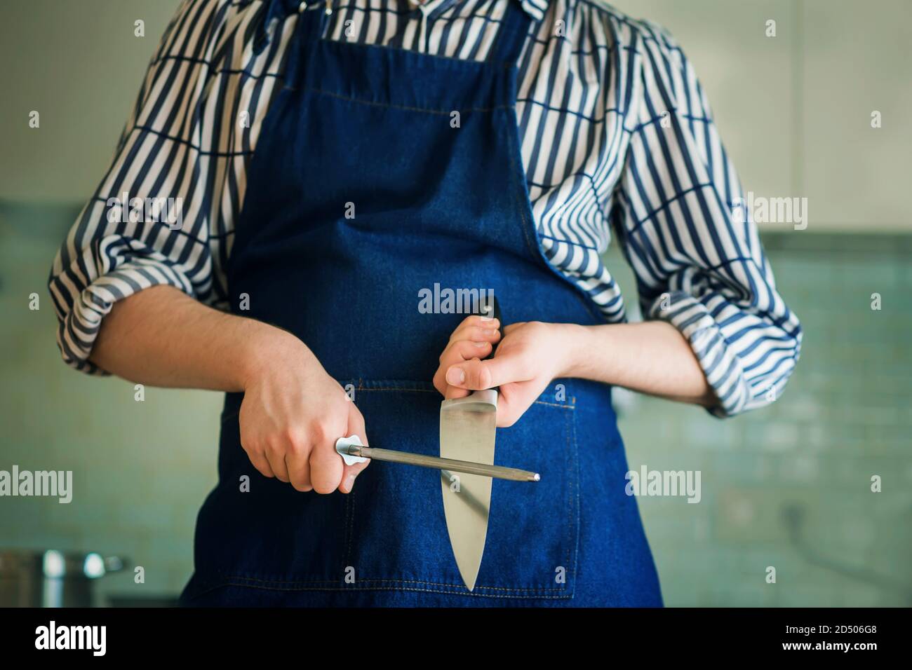 Professional chef knife, peeling knife and sharpening steel on wood cutting  board over a kitchen table. Chef working tools. Modern kitchen utensils  Stock Photo - Alamy