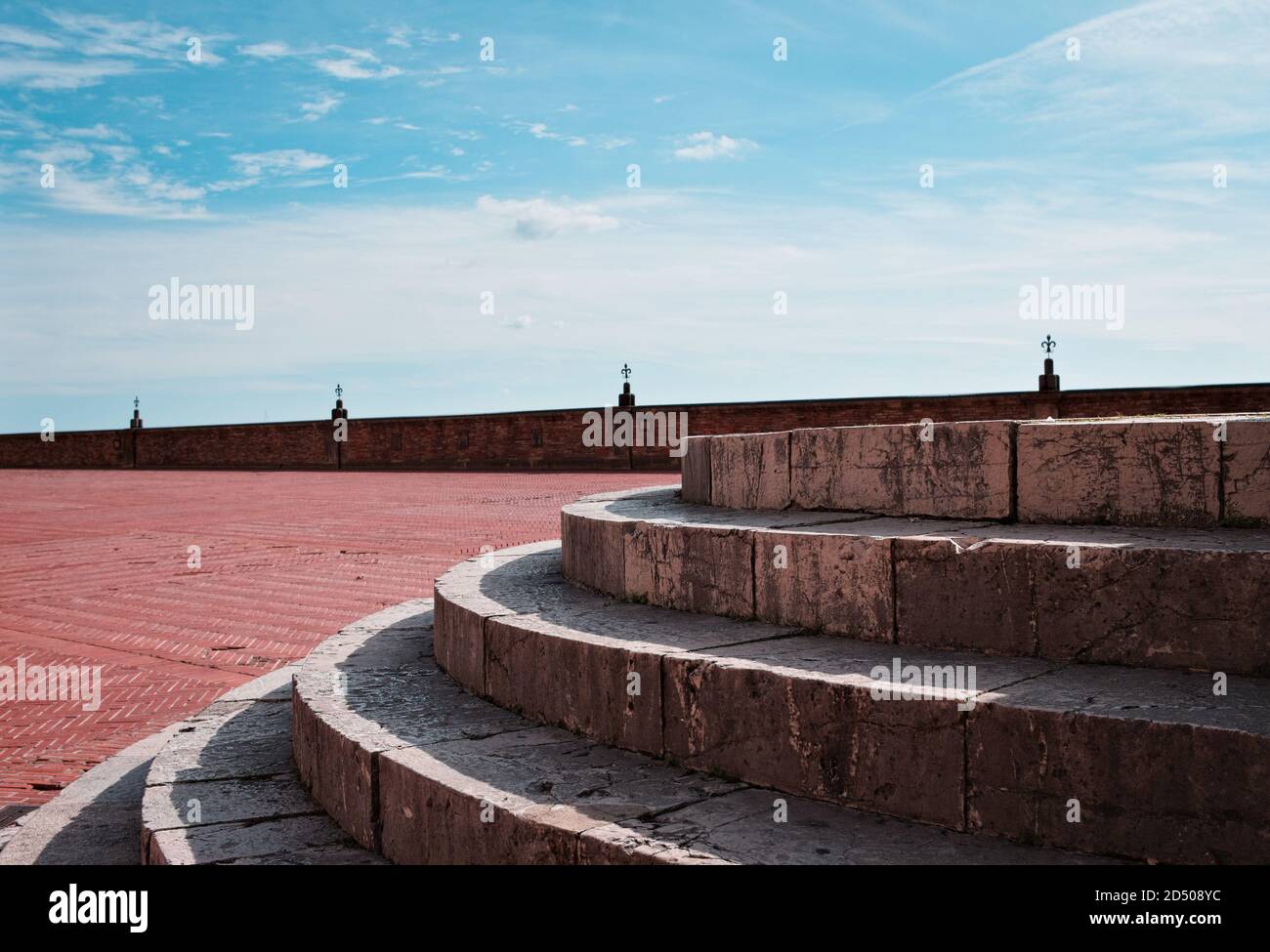 A detail of a circular stone staircase in an empty square (Gubbio, Umbria, Italy) Stock Photo