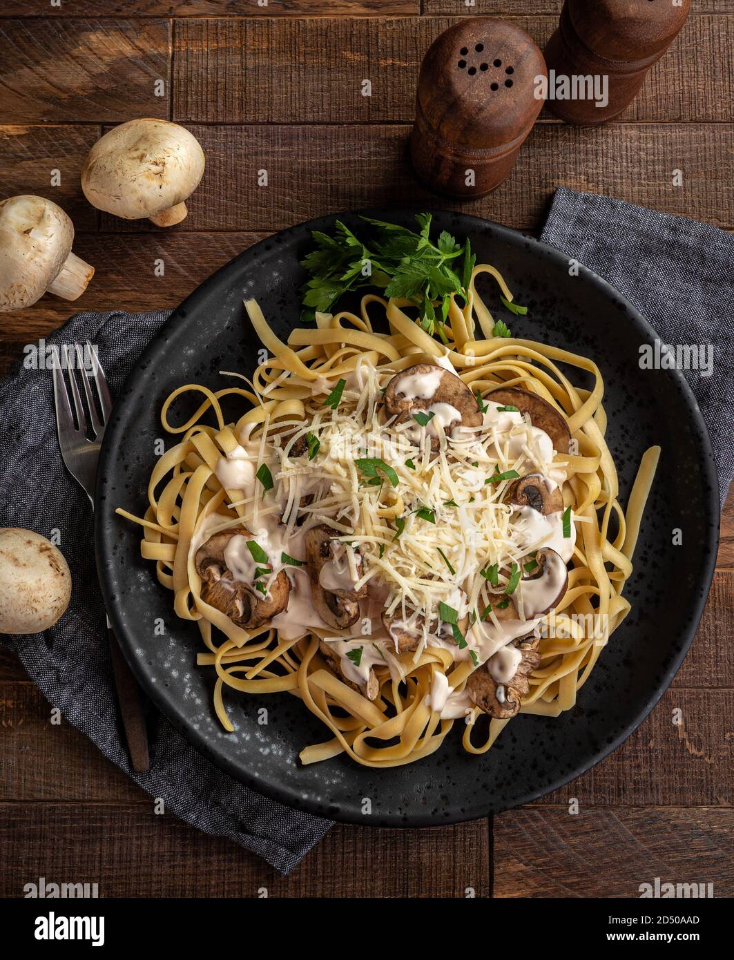 Creamy fettuccine alfredo with mushrooms and shredded parmesan cheese