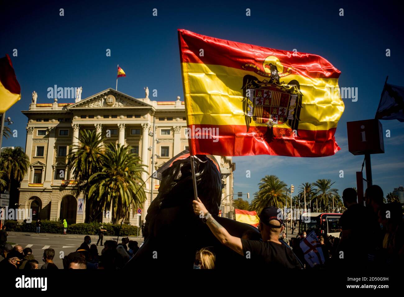 Barcelona, Spain. 12th Oct, 2020. A man waves a Spanish Francoist flag as unionist gather at the bottom of Columbus statue in Barcelona during Spain's National Day. Credit:  Jordi Boixareu/Alamy Live News Stock Photo