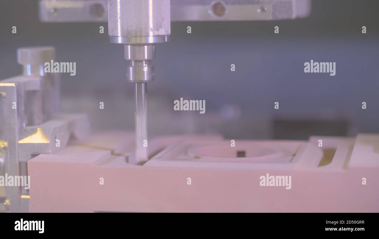 CNC engraving - milling machine cutting wooden workpiece at futuristic ...