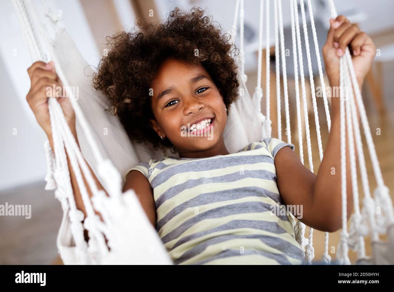 Happy playful preschool child girl having fun at home Stock Photo