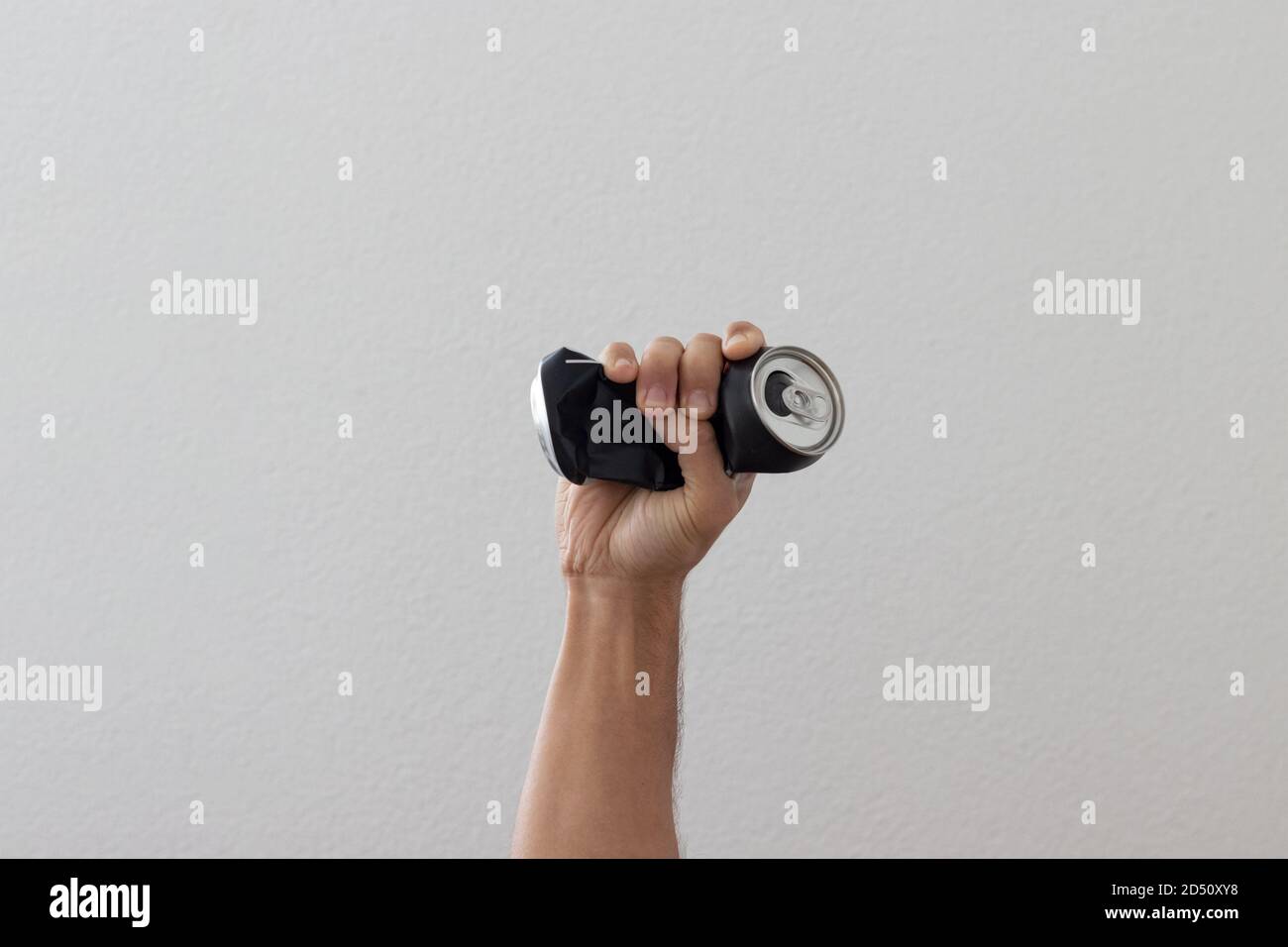 Hand crushing used can representing movement against pollution and for