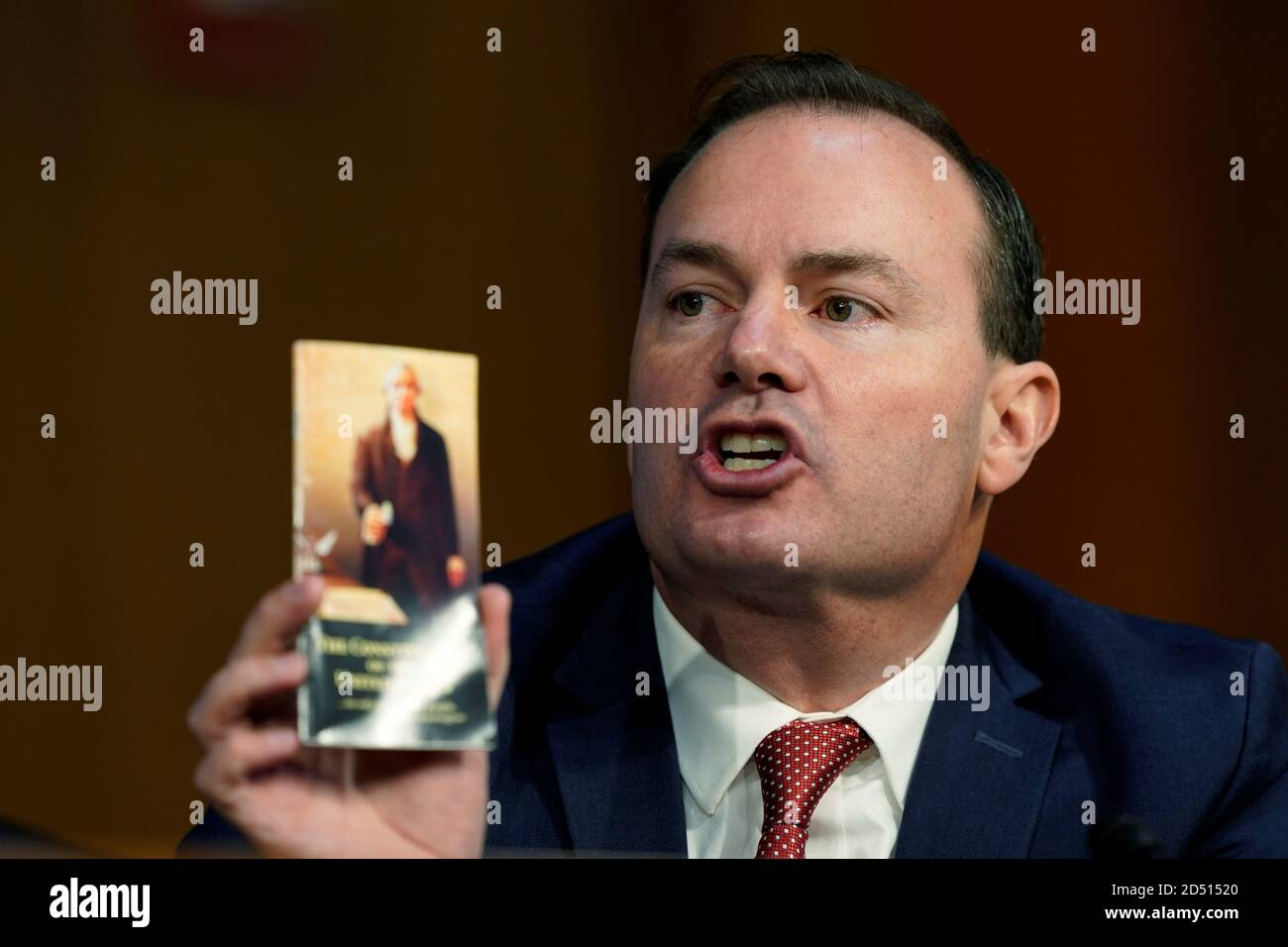 U.S. Senator Mike Lee (R-UT), who recently tested positive for coronavirus disease (COVID-19), holds a pocket copy of the U.S. Constitution as he speaks during of a confirmation hearing of Judge Amy Coney Barrett on Capitol Hill in Washington, D.C., U.S., October 12, 2020. Susan Walsh/Pool via REUTERS Stock Photo