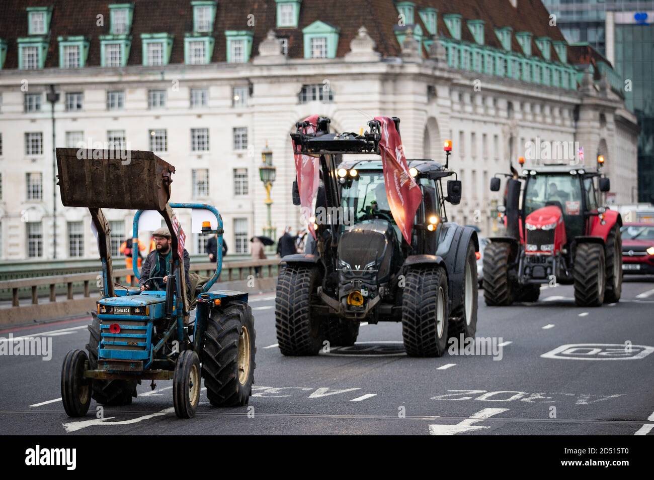 Farmers in tractors take part in a protest over food and farming standards, organised by Save British Farming (SBF), Westminster, London, on the day the amended Agricultural Bill returns to the House of Commons. Stock Photo