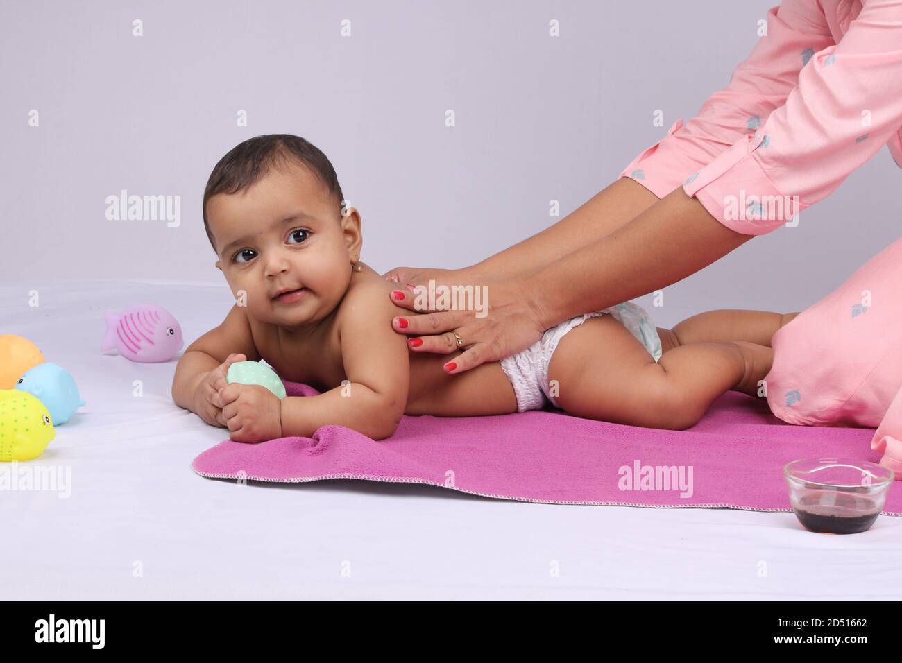 Indian Mother massaging her lovely baby. Stock Photo