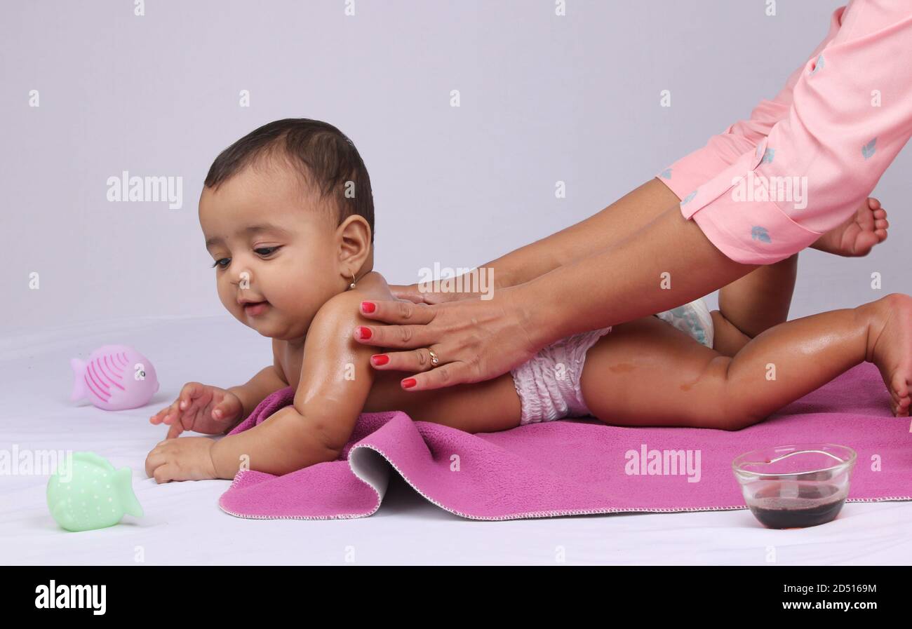 Indian Mother massaging her lovely baby. Stock Photo