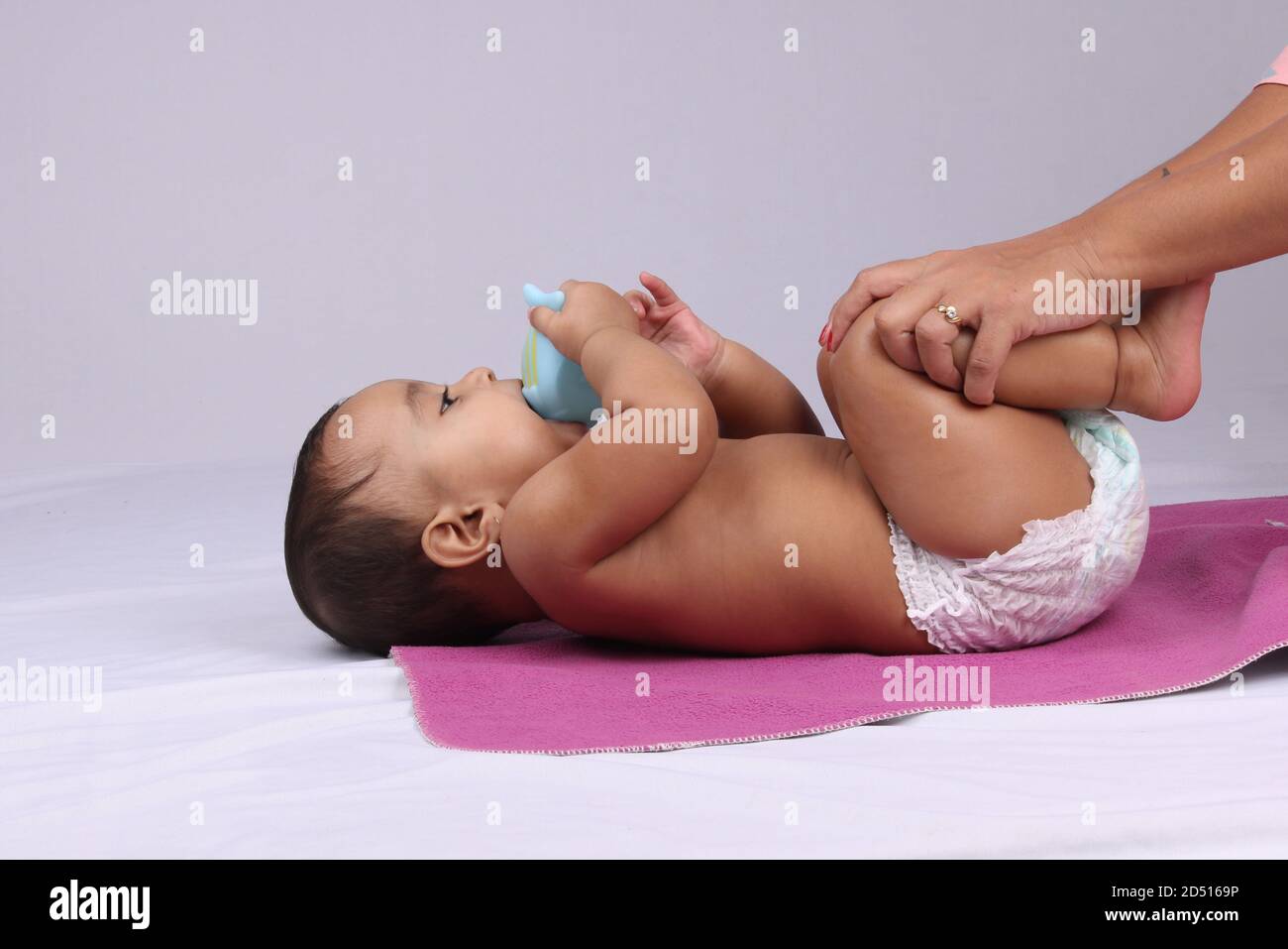 Indian Mother massaging her lovely baby. Stock Photo