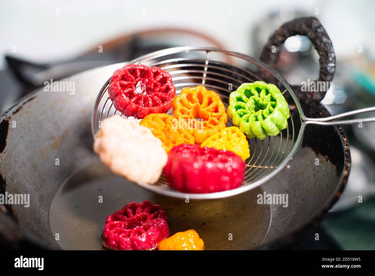 shot of colorful Fryums being shaken to remove excess oil from this