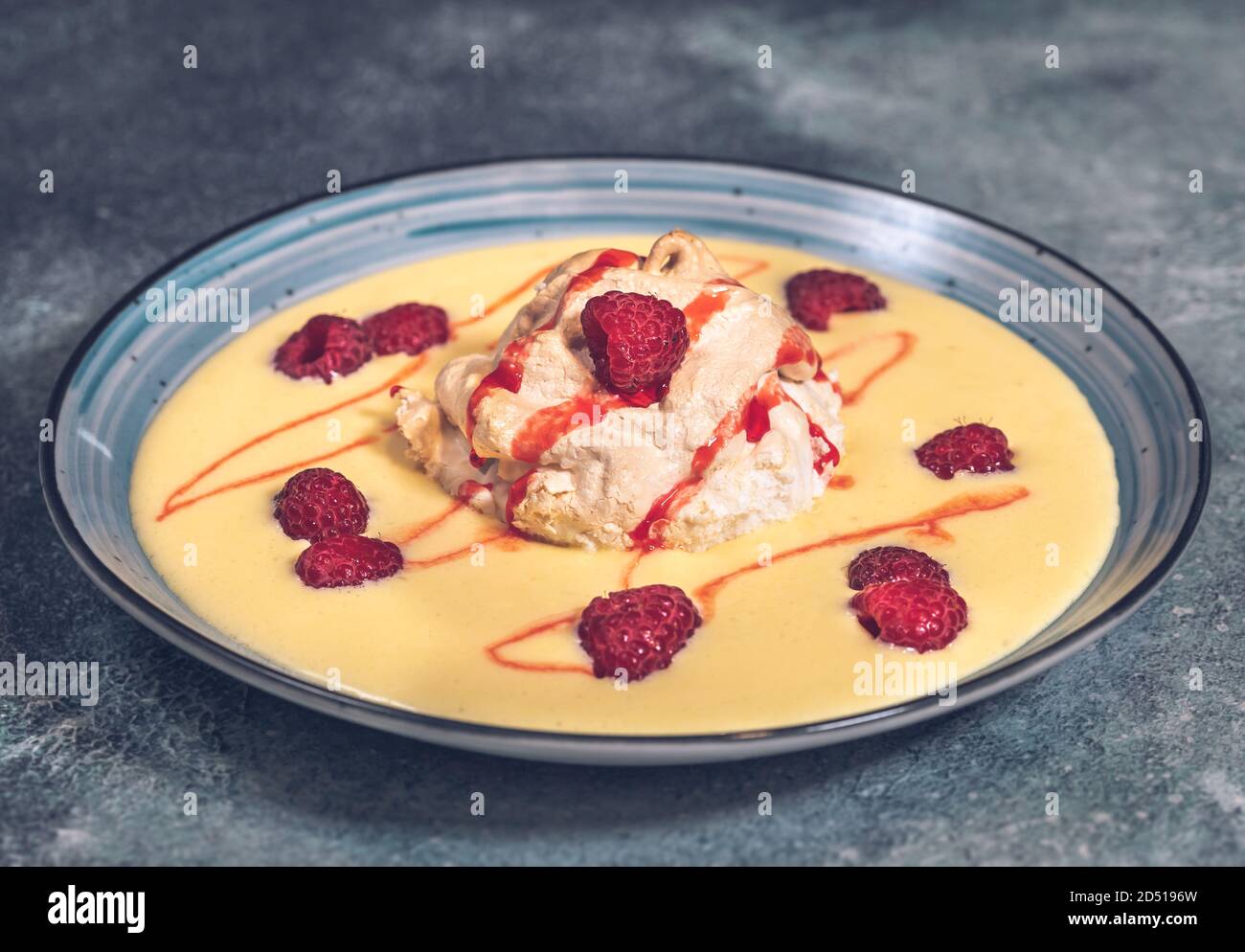 Floating island dessert made of meringue floating on vanilla custard