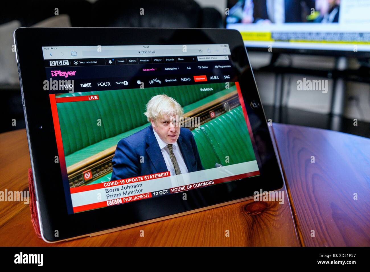 Chippenham, Wiltshire, UK. 12th October, 2020. The UK Prime minister's announcement in Parliament to inform MP's of the introduction of a COVID-19 ‘three-tier’ system for England is watched on an Ipad in Chippenham, Wiltshire. Credit: Lynchpics/Alamy Live News Stock Photo