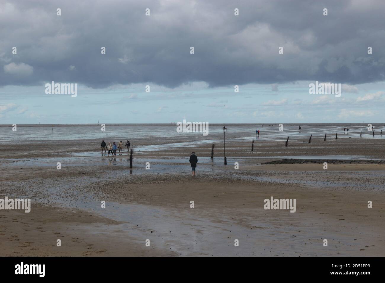 The North Sea during low tide in Cuxhaven-Salenburg. People walk on the mud  flats. North Germany, Europe Stock Photo - Alamy