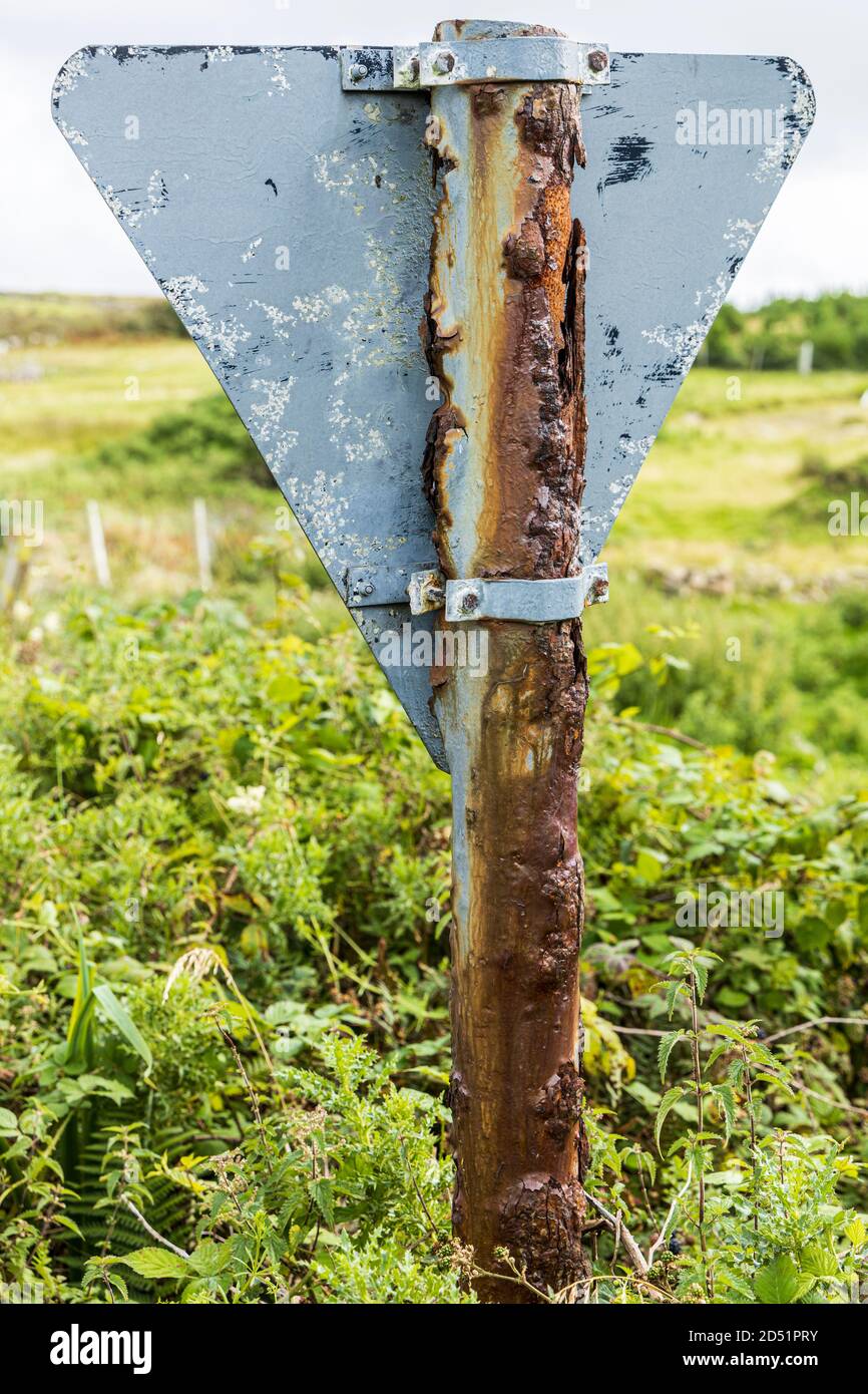 Heavily corroded and rusted metal post for a roadsign is a testament to the severe weather conditions, seen along the Killeen loop walks near Louisbur Stock Photo