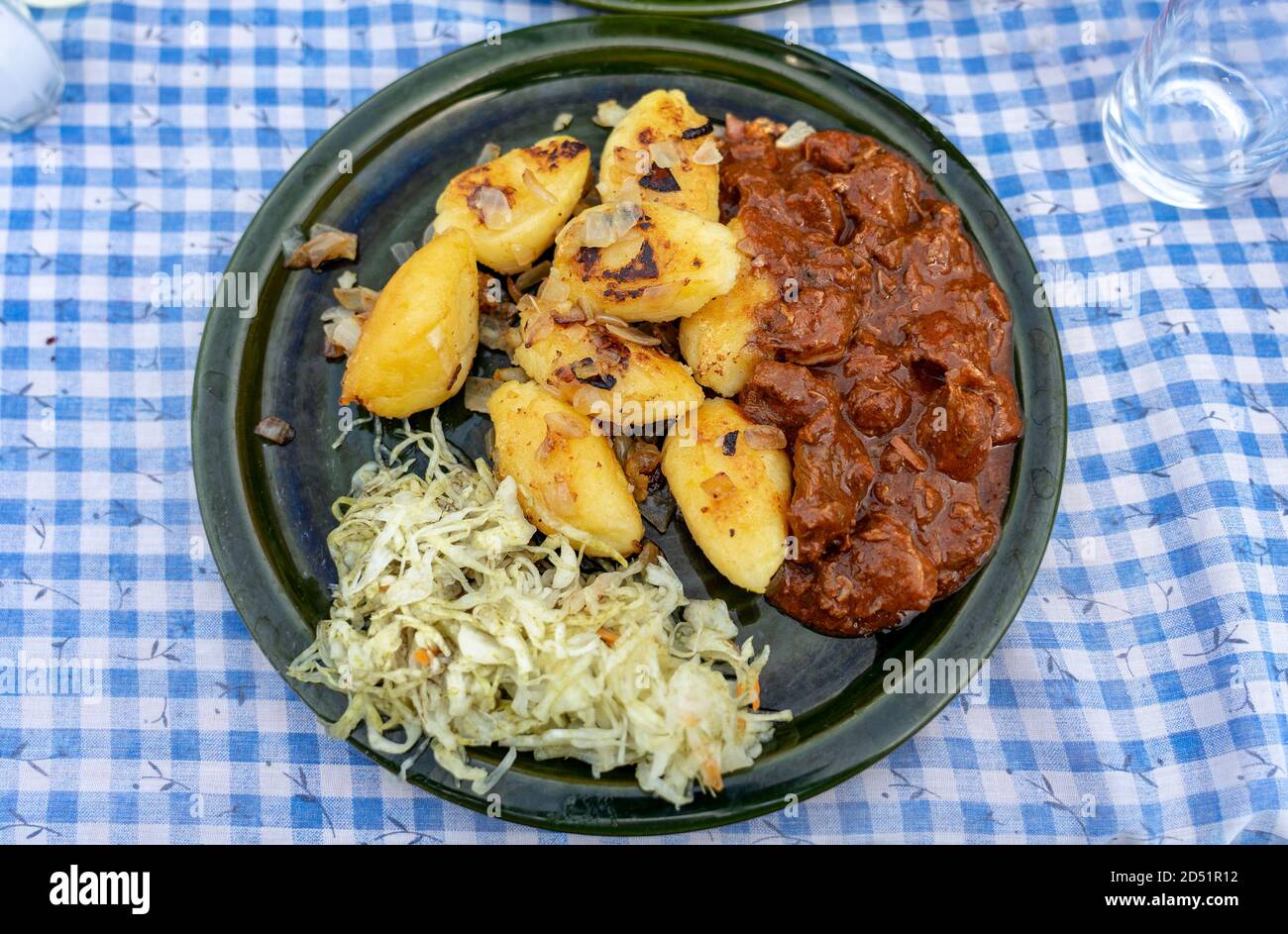 traditional hungarian Őrség style Dödölle pastry potato dumpling with pörkölt stew and cabbage Stock Photo