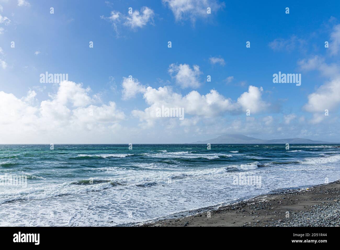 Waves rolling in to shore on a windy day in Clew bay with views to