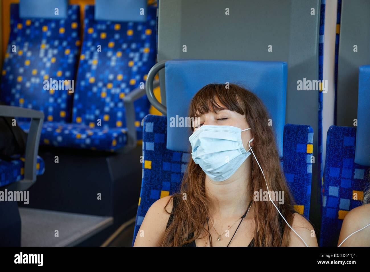 Young woman on a train wearing masks Stock Photo Alamy