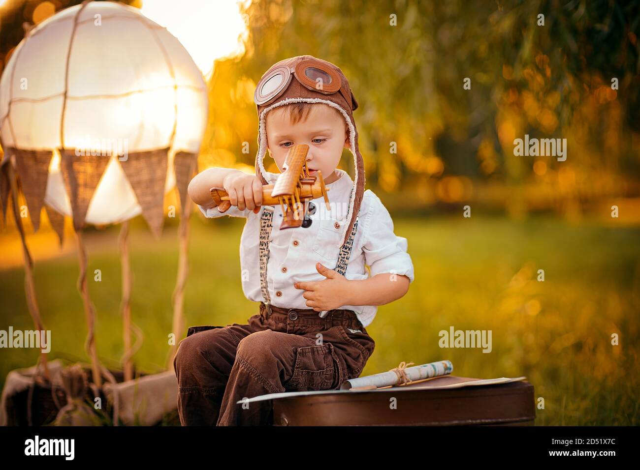 A little boy dreams of becoming a pilot. Vintage aviation hat. Stock Photo