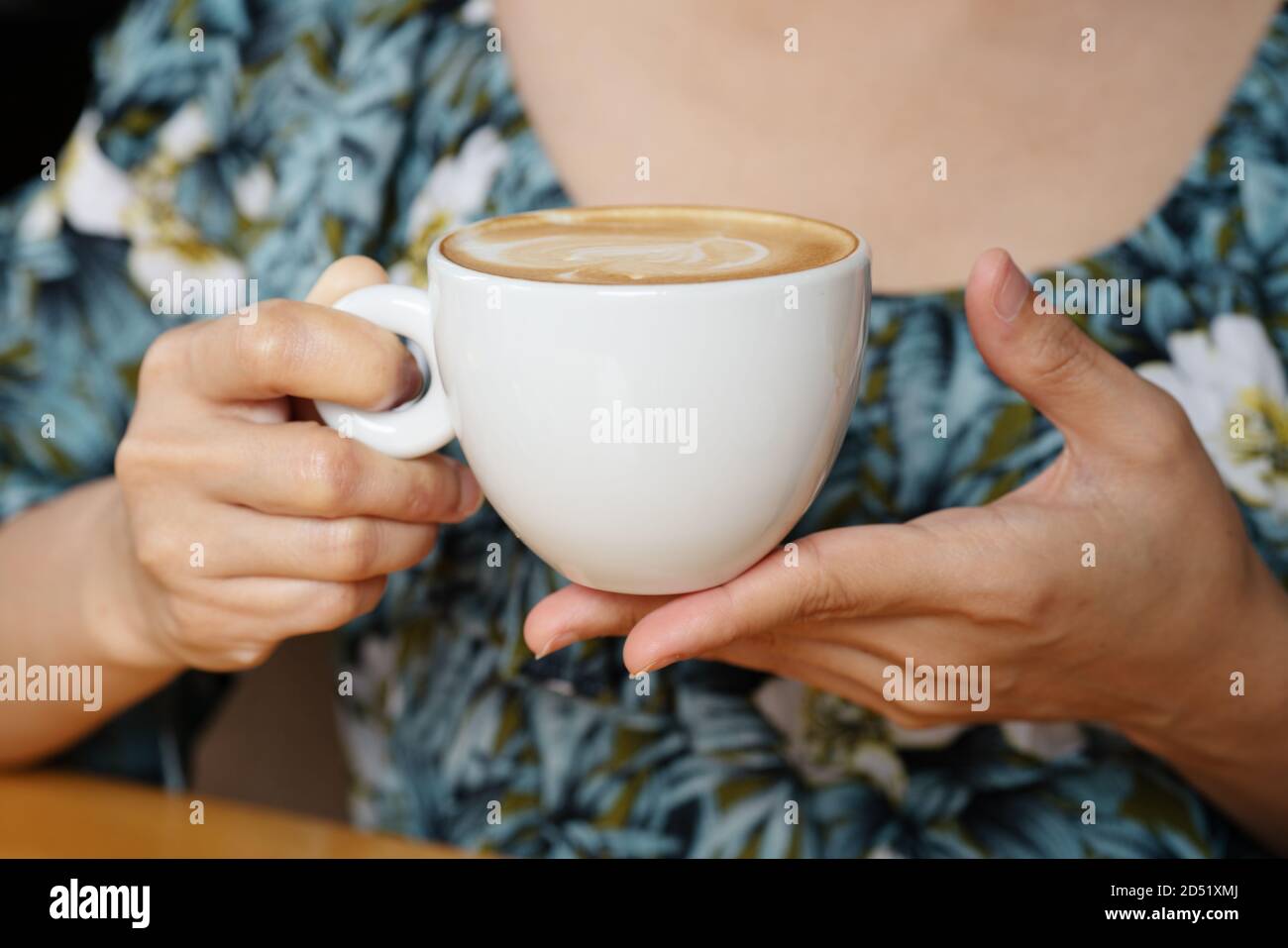 women hands holding hot cup of coffee or tea in morning sunlight Stock ...