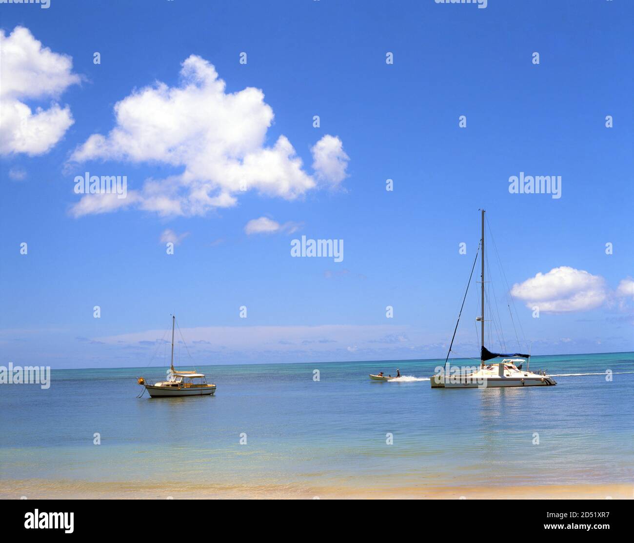 Speed boat passing yachts in seychelles hires stock photography and