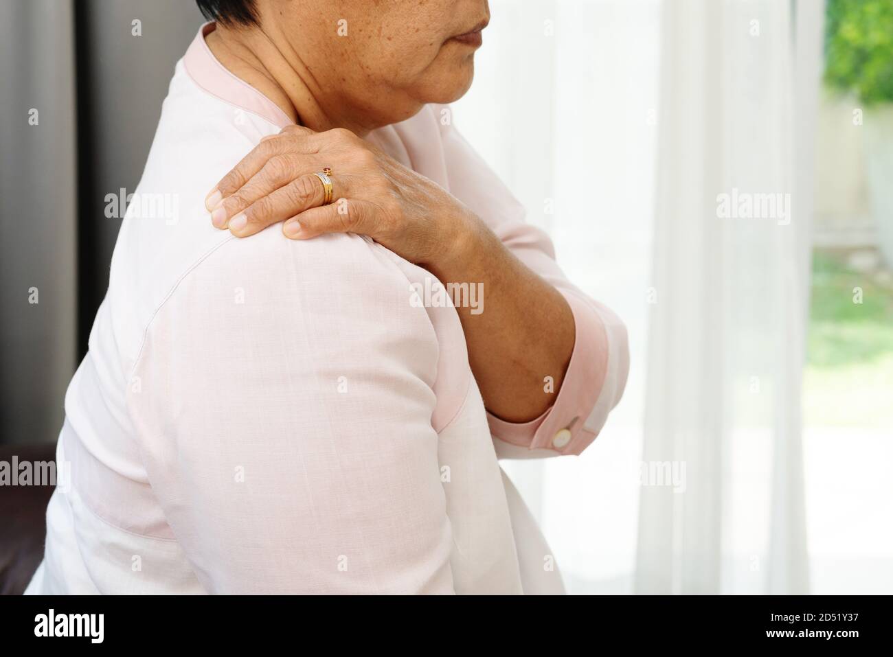 neck and shoulder pain, old woman suffering from neck and shoulder injury, health problem concept Stock Photo